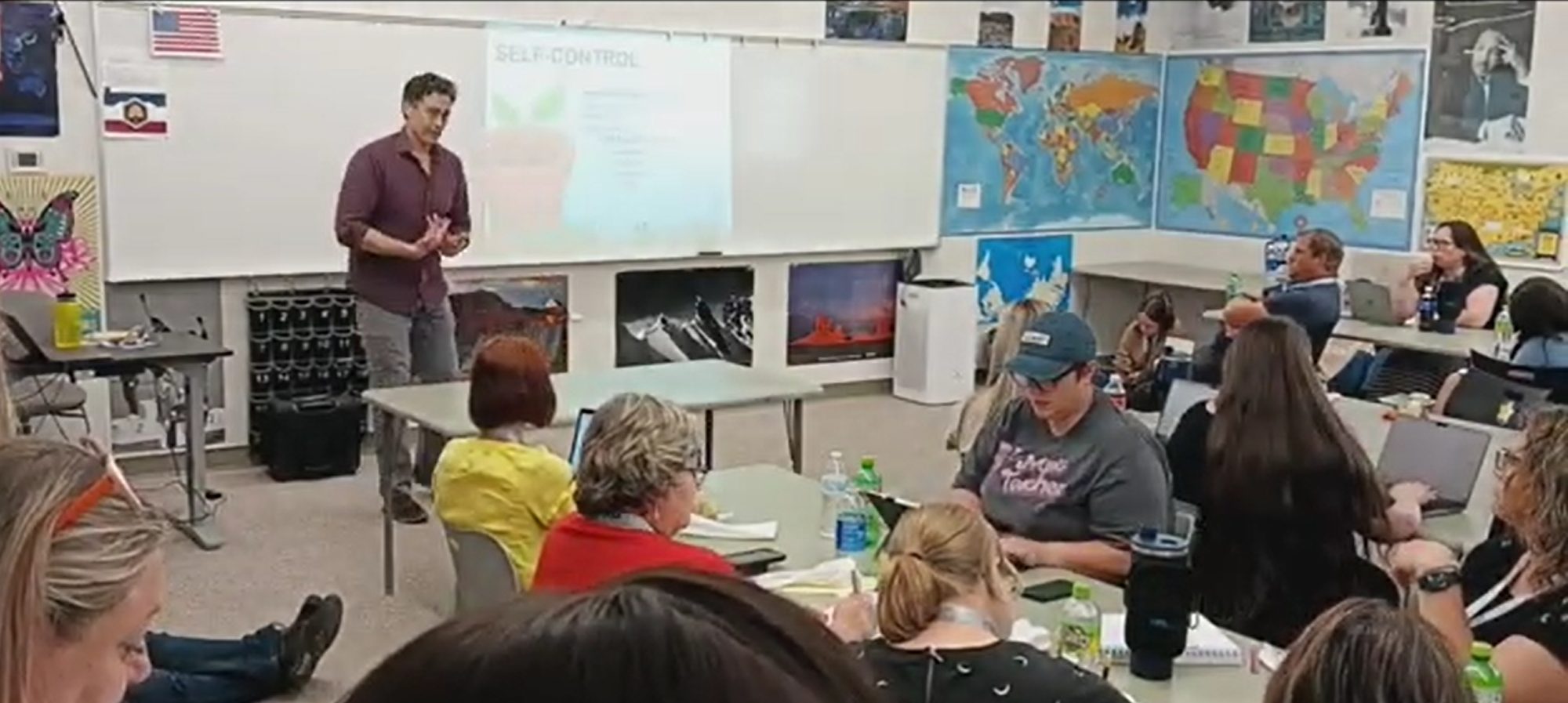 Kenneth Applegate teaching a room of educators seated at tables