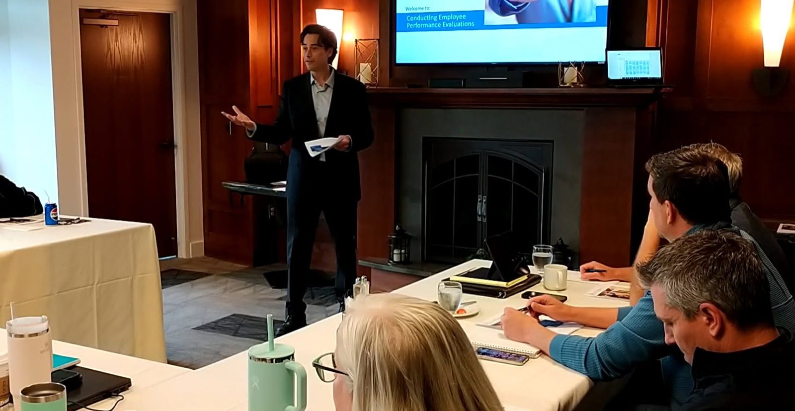 Kenneth Applegate presenting to a small group at conference tables